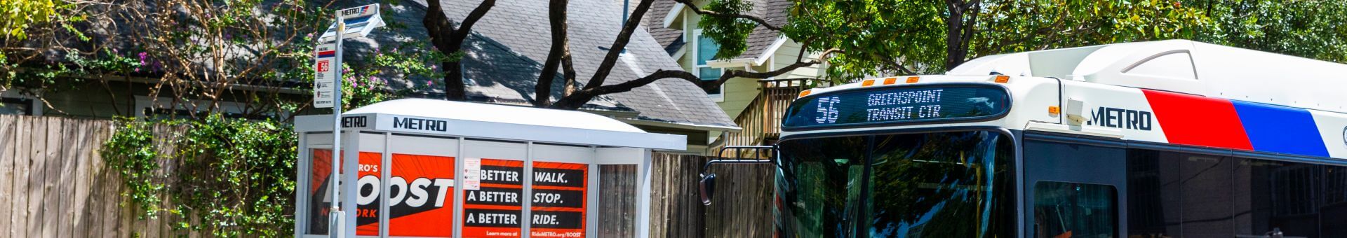 56 Airline / Montrose bus riding past bus shelter designed during METRONext project.